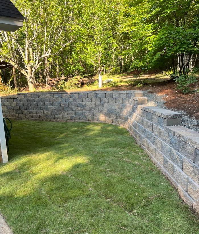 Curved retaining wall with steps and new lawn