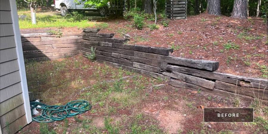 Failing timber retaining wall before rebuild