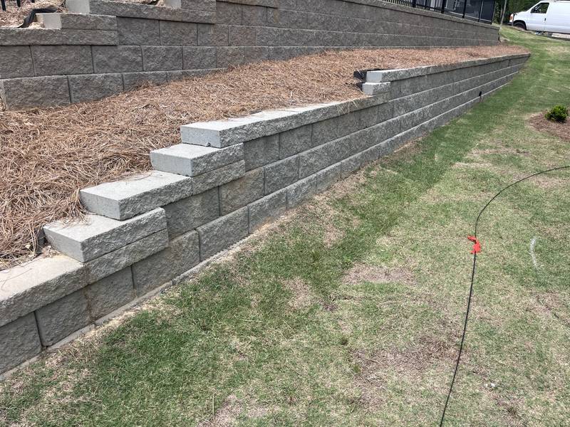 Tiered block retaining walls with pine straw terraces
