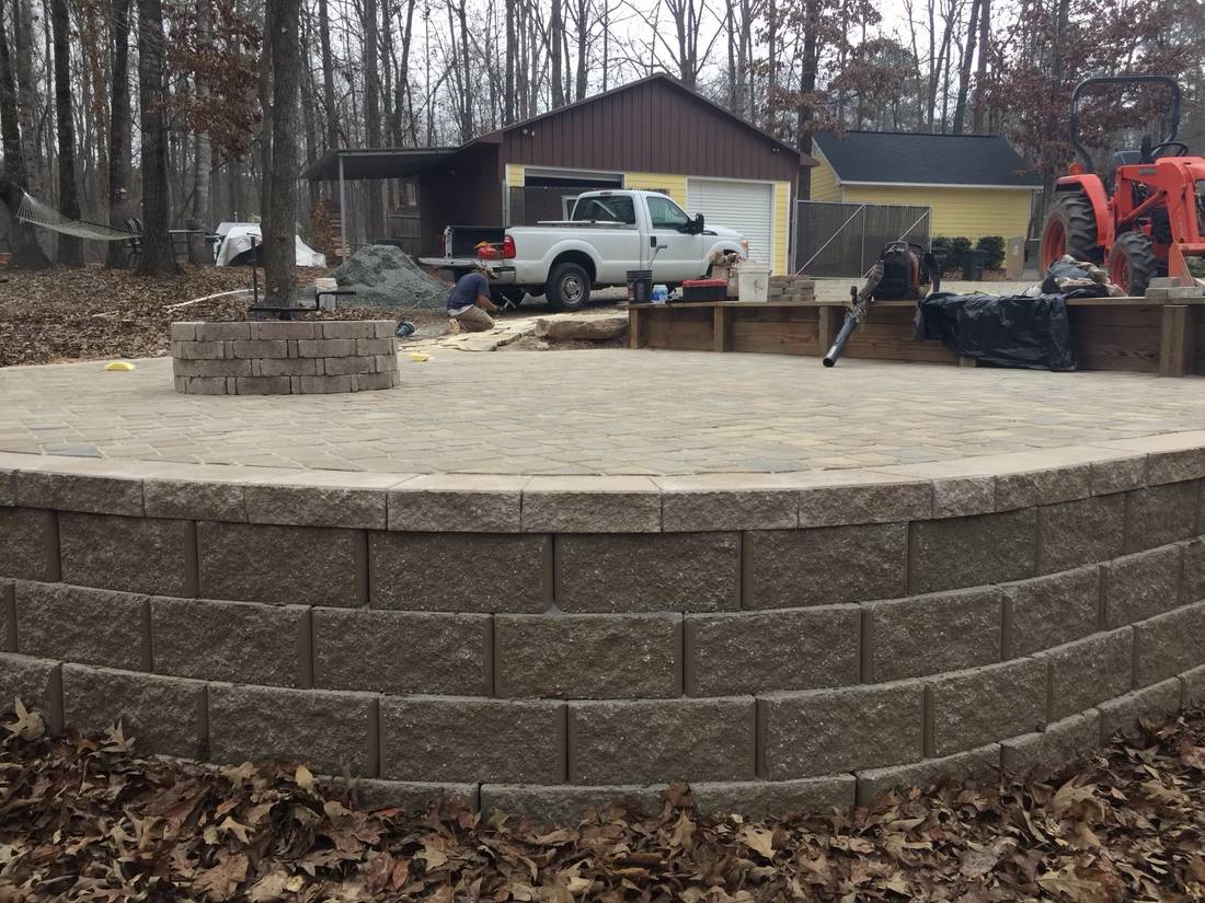 Raised paver patio with block seat wall and fire pit