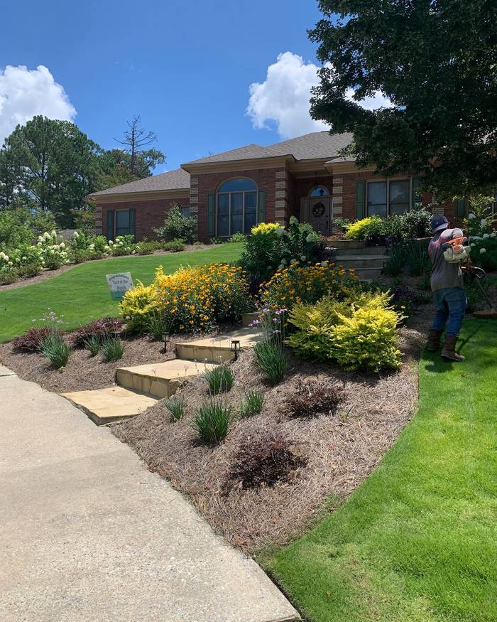Front yard beds with flagstone steps and blooming perennials