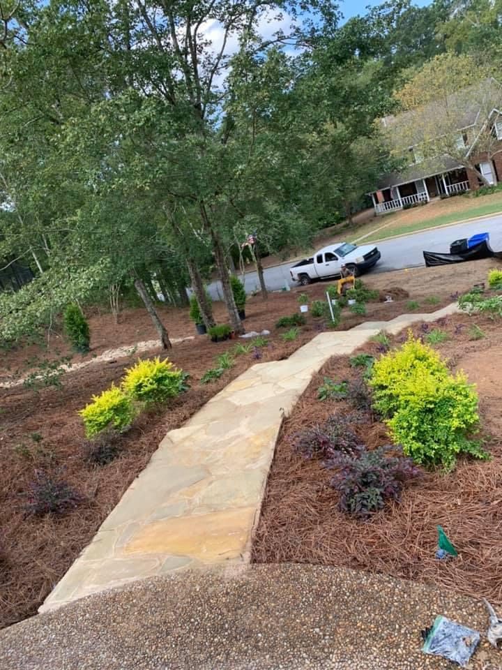 Flagstone front walk through new beds